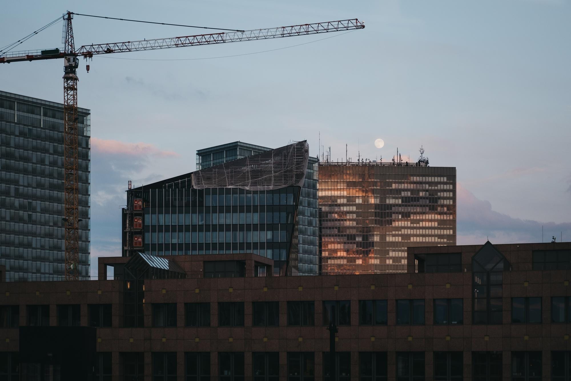 Tower crane and curtain-wall construction at dusk